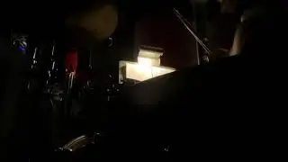 Playing drums from the pit of a musical