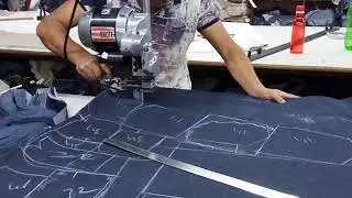 Fabric cutting with straight knife in garment factory