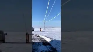 Power Line crews removing frost from the power lines.