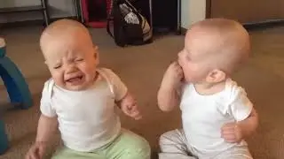 Twin girls fight over pacifiers