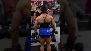 muscular female at the gym//hot shoulder exercise