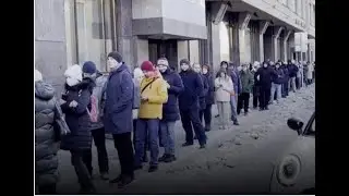 Desperate Russians queue for hours to withdraw money from banks as rouble plummets
