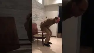Older adult standing up from a chair. Mas