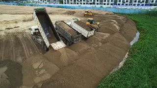 Powerful Extreme Bulldozer Working Pushing Black Sand Into Water - Dump Truck Unloading Sand