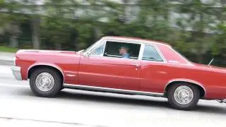 1964 Pontiac GTO leaving a car show
