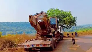 Excavator machine loading and unloading on the trailer  