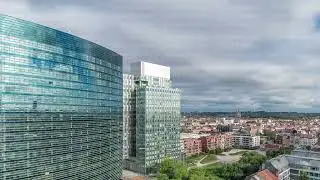 Aerial timelapse of Brussels urban landscape blending office skyscrapers with residential areas.