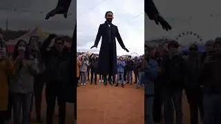 Can you find him? 😊 magician in an open circus arena levitates above the ground while people