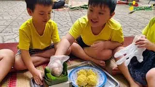 Children experience the activity of wrapping banh chung (traditional Vietnamese rice cakes) for T...
