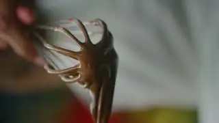 MELTED CHOCOLATE DRIPPING SLOWLY OFF A WHISK 4K