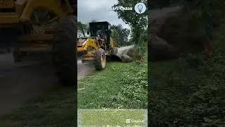 Excavator at cleaning and ploughing roadside for road construction