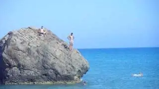 Kids diving off a rock next to Aphrodites Rock, Cyprus