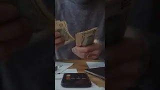A Person Counting Money and Using Calculator