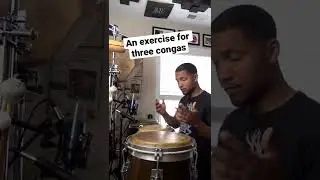 Playing three conga drums