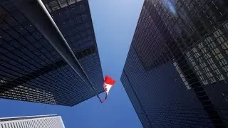 Rotating Around Tall Office Buildings Downtown With Tall Canadian Flag In Daylight 2 | Stock