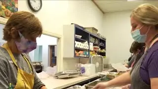 Volunteers serve hot holiday meals