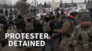 ICE officers detain protester as Minnesota demonstration turns tense