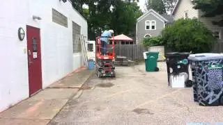 Mural Artist learning the Scissors Lift