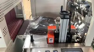 Automatic film wrapping machine for rubber tire