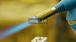Lighting A Blowtorch And Adjusting The Flame
