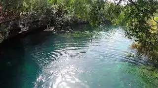 Jumping off the cliff at Pandarosa  Cenote near Playa del Carmen, Mexico