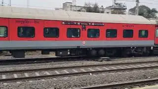 Dakshin Express with LHB Coach Slowly Entering Station on other Side of Fast Moving Goods Train