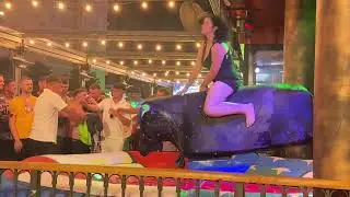 Brunette Girl in Black Dress Riding on a Mechanical Bull 🐂 in Benidorm | 4K