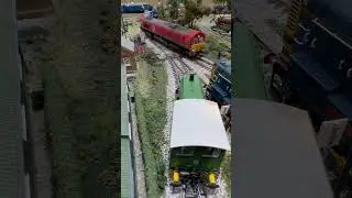 Passing around the wide bend a Top and Tail class 66 Sandite rail head train.