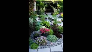 A lush, multi layered garden design that blends formal elements with abundant, naturalistic planting