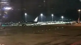 KLM Boeing B777-300ER taxiing and KLM Boeing B787-9 towed to stand at Amsterdam Schiphol Airport 