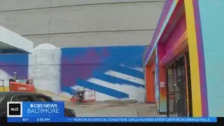 Artist brightens community with mural on auto repair shop ahead of Baltimore's Artscape