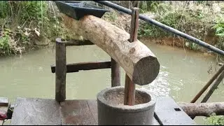 Grinding rice using ancient stone mortars./P133