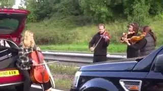String quartet play on M5 on Somerset and Devon border, near Taunton