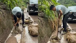 A kind-hearted person single-handedly dealt with a large rockfall in the roadside drainage ditch.