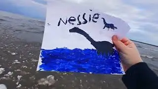 Holding Prayia's Painting of The Loch Ness Monster on the Frozen Shore of Lake Ontario in Charlotte,