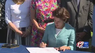 Raimondo signs new clean energy legislation into law