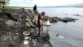 Preparing fish for cooking at Cildir Lake, Turkey