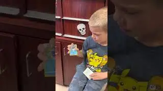 Grayson opening Pokémon cards. October 2022.
