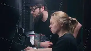 Female sound engineer uses mixing console, creates song with producer