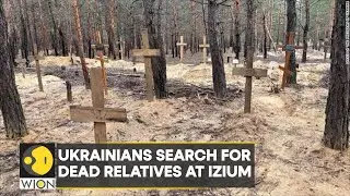 Ukrainians search for their dead relatives at Izium grave site |  Latest News | WION