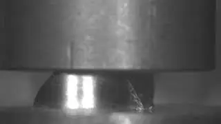High speed compression test. Strong metal specimen.
