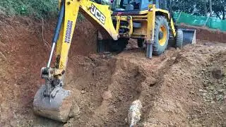 Jcb 3dx digging and gathering soil 