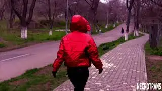 A girl in bright red metallic shiny down jacket with a large hood, leather leggings + MP-3 gas mask