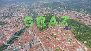 Inscription on video. Graz, Austria. The historic city center aerial view. Mount Schlossberg (Castle