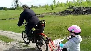 Bicycle trailer for adult walks with children. Peruzzo Trail Angel in action.