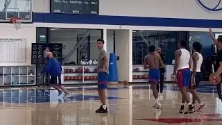 Justin Edwards, and VJ Edgecombe post-practice three-point shooting drill on the far court.