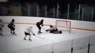 Isaac Flatley around dman attempts one handed back hand tuck linemate finishes