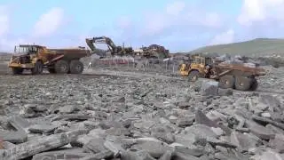 ASHLEIGH CONTRACTS Offloading a barge full of large rock armour