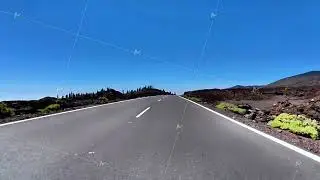 A Scenic Open Road Running Through a Beautiful Lush Landscape Beneath a Clear Blue Sky