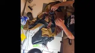 Time lapse of repairing a huge tear in a latex catsuit